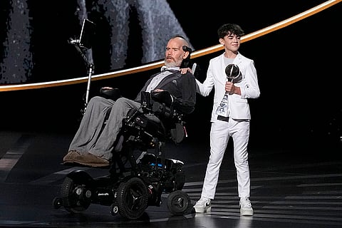 Steve Gleason, left, with his son Rivers, recieves the Arthur Ashe Award for Courage